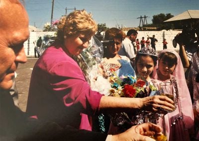 Jo Ann accepting flower from locals