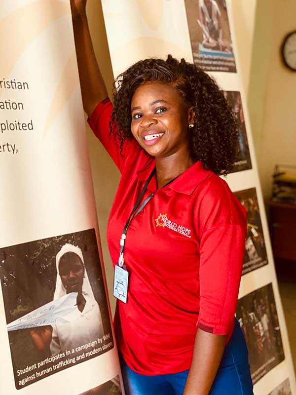 Bintu in front of banner displays