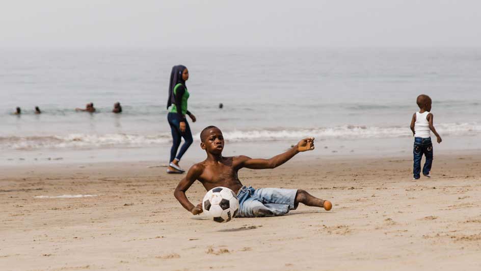 Ibrahim playing soccer on beach