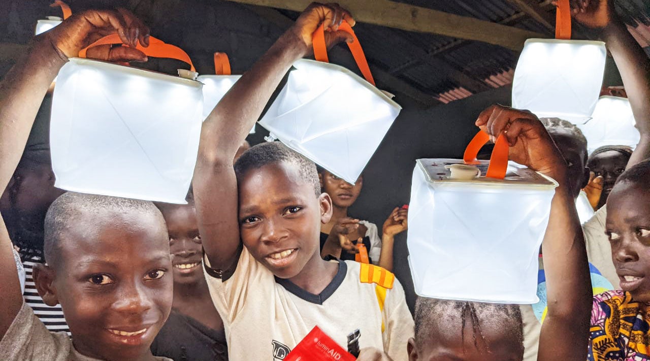 Children holding solar-powered lanterns