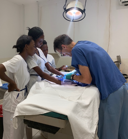 Dr. performing surgery on a patient in Haiti 