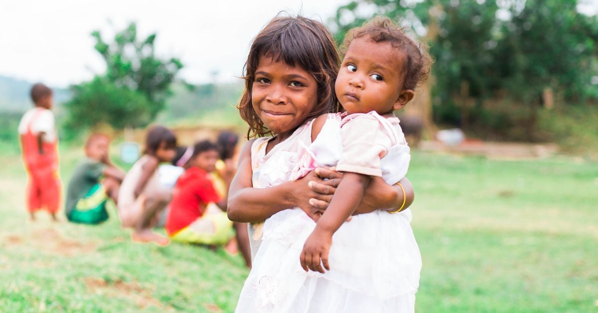 Filipino chid holding a baby