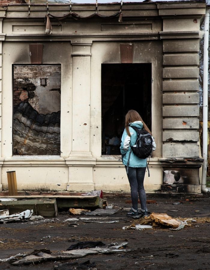 Girl outside blown up building