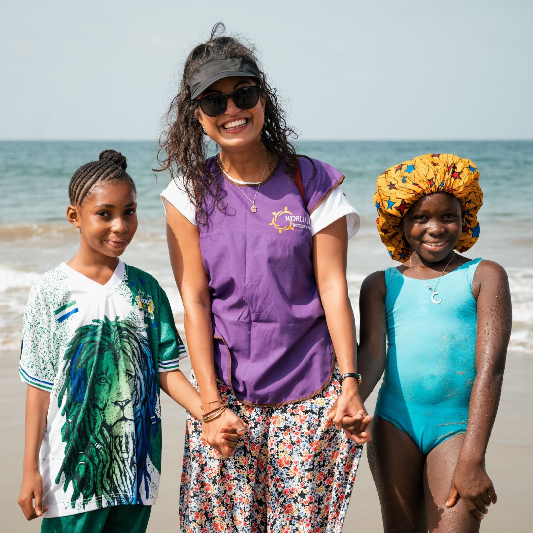 ETC employee with two girls at the beach