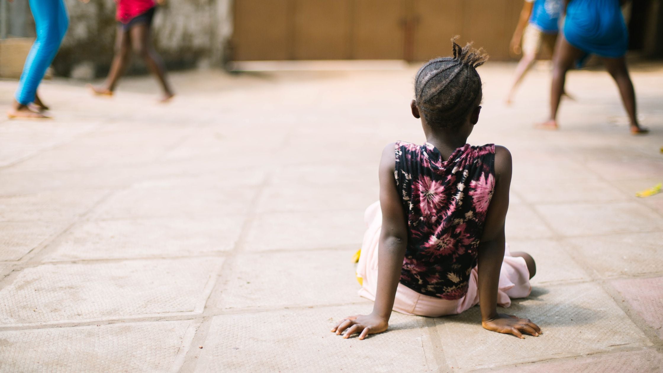 young girl sitting on the ground
