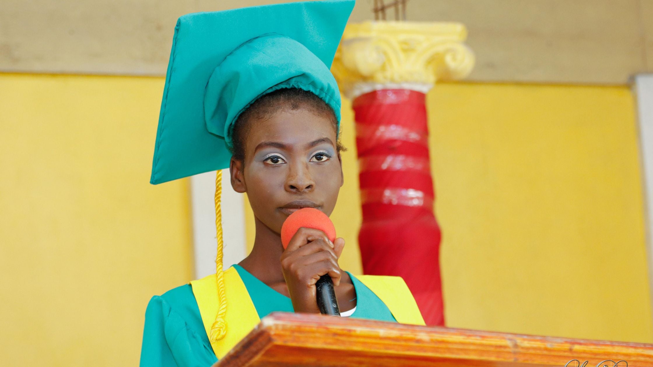 Young woman speaking at her graduation in Haiti