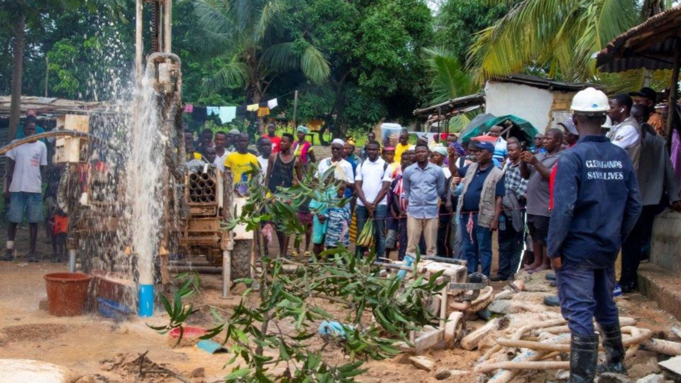 Water gushing out from the newly drilled well in Sierra Leone