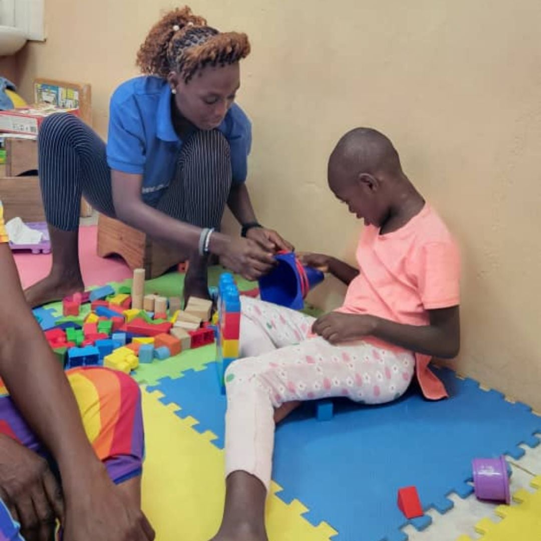 Volunteer doing PT with ETC Child