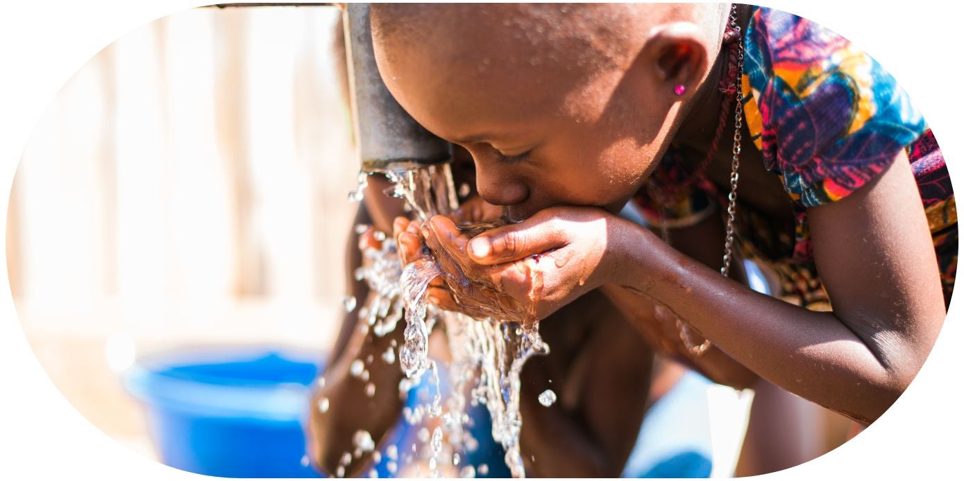 Girl drinking clean water from well